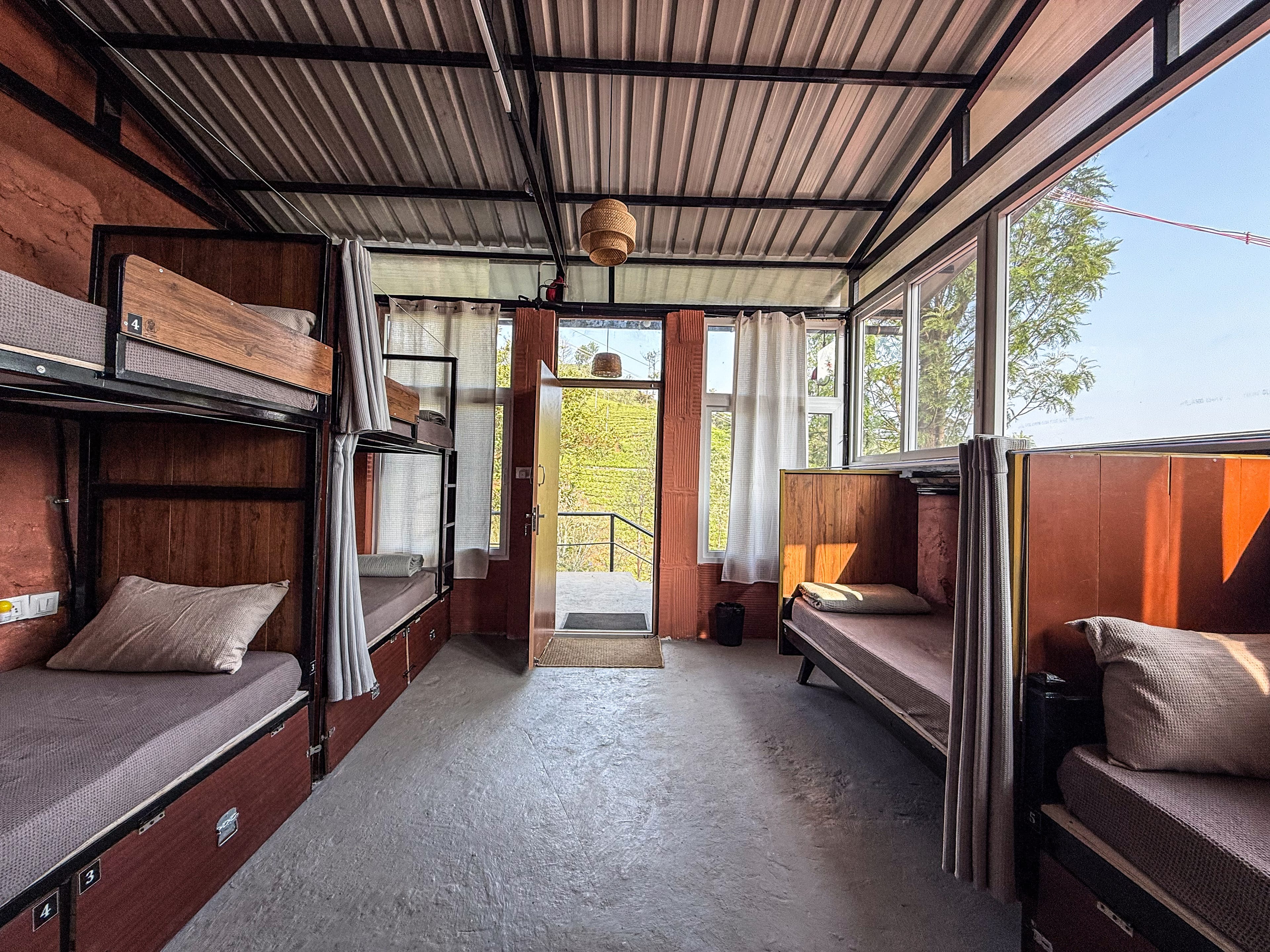 The heritage dormitory with original teak bunk beds and warm morning light